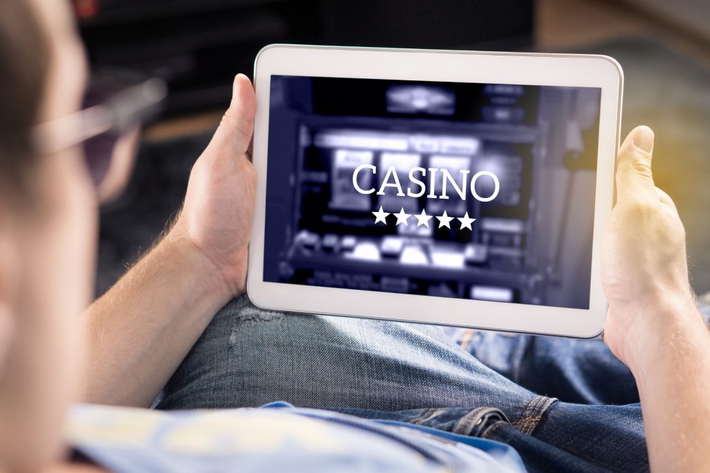 Guy Playing Online Casino using his Tablet
